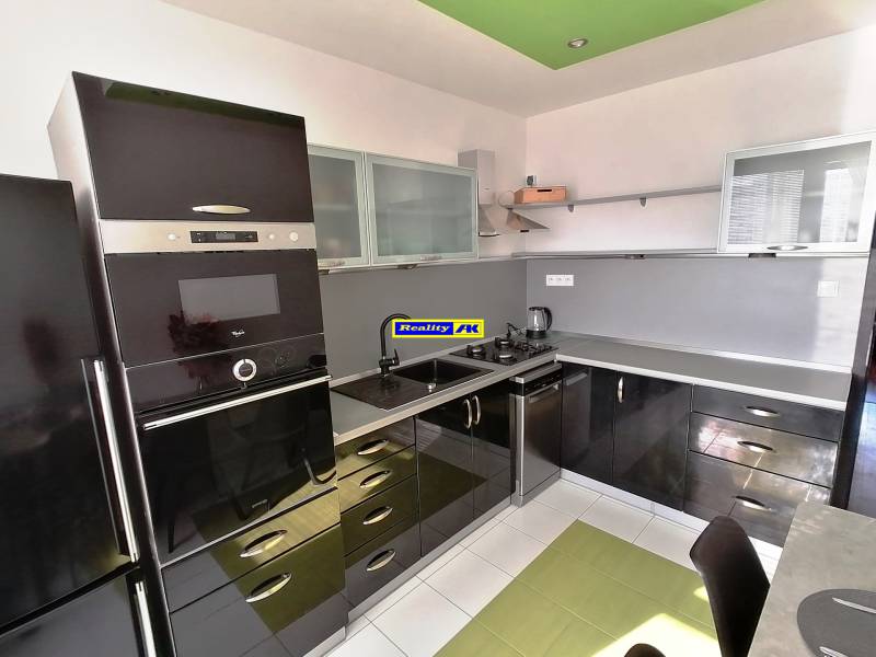 Moderná kuchyňa s čiernymi skrinkami a bielej podlahy v 3-izbovom byte.